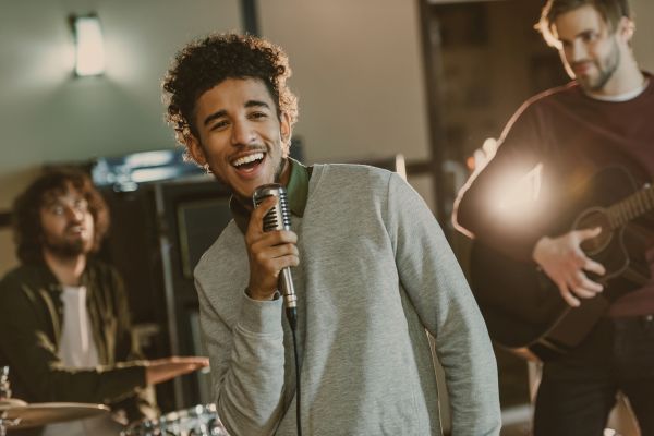 young happy rock band musicians performing song
